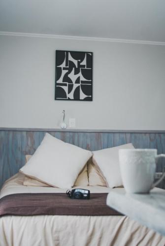 a bed with a pair of glasses on top of it at Departamentos Santa Bárbara Osorno in Osorno
