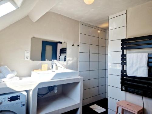 a white bathroom with a sink and a mirror at Marine 4 in Cherbourg en Cotentin