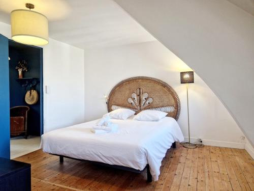 a bedroom with a large bed with white sheets at Marine 4 in Cherbourg en Cotentin
