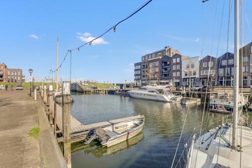 a group of boats docked in a marina with buildings at Huize wees Nobel In het centrum Van Oud Beijerland dicht bij Rotterdam in Oud-Beijerland