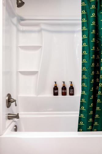 a bath tub with three bottles in a bath tub at Fresh & Comfy House with Hot Tub, Pool Table, & BBQ in Eugene