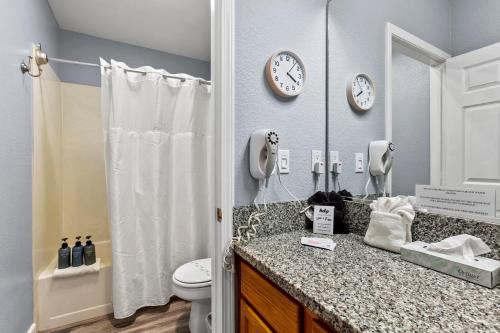 a bathroom with a sink and a toilet and a mirror at 444 Pier Ave. #403 in Oceano