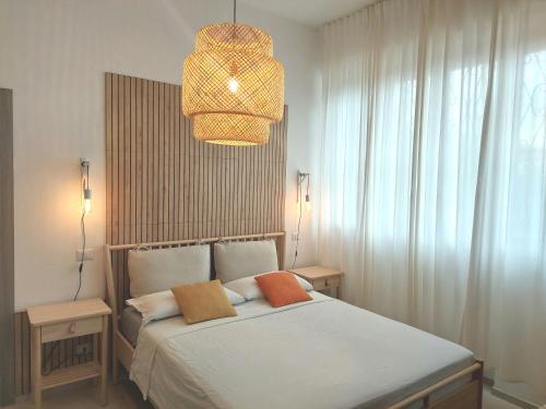 a bedroom with a bed and a chandelier at Villa Bagno Santo in Sarteano