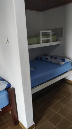 a bedroom with a bunk bed with blue sheets at Hotel Flórida in Salinópolis
