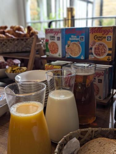a table topped with glasses of milk and bread at The Ship Inn in Oundle