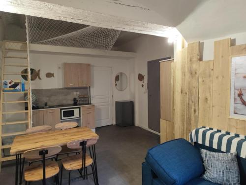 un salon avec une table et une cuisine dans l'établissement La Cabine du Large 2, à Montélimar
