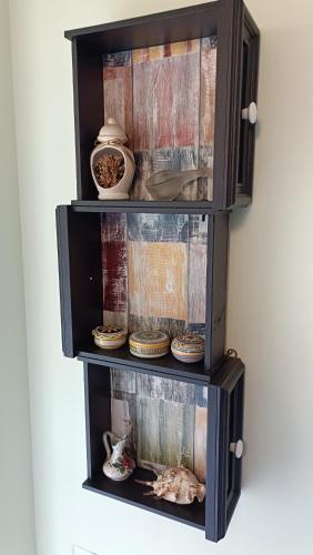 a wooden cabinet with plates and bowls in it at La casetta rossa in Collicello