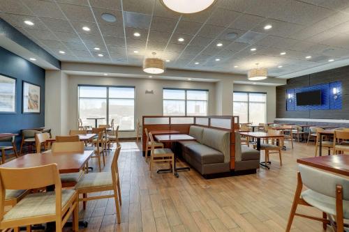 a restaurant with tables and chairs and a tv at Drury Plaza Hotel Mt Vernon in Mount Vernon