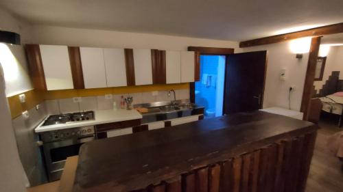 a kitchen with a sink and a stove top oven at Residence nel verde e nei trulli in Martina Franca