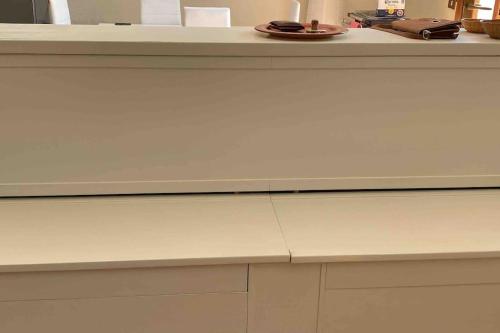 a counter top with a white counter top at Appartamento immerso nella tranquillità in Bobbio