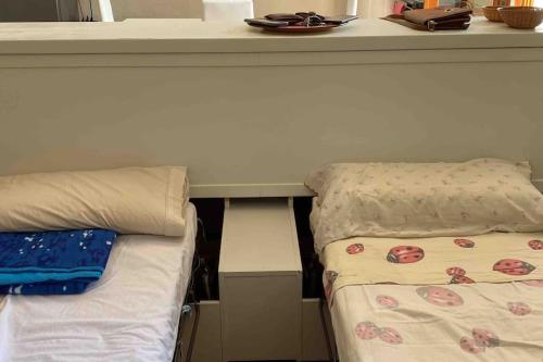 a room with a bed next to a counter with a table at Appartamento immerso nella tranquillità in Bobbio