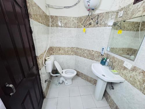 a bathroom with a toilet and a sink at Bella in Mohali