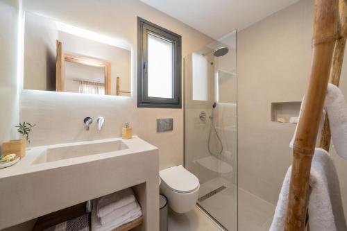 a bathroom with a sink and a toilet and a shower at Ionian Infinity Villa in Ayia Evfimia