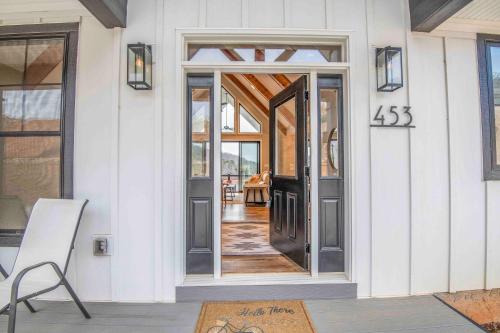 a front door of a house with sign on it at Luxury Lakeside Living at Knot Working on Norris Lake in La Follette