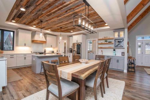a large kitchen with a wooden table and chairs at Luxury Lakeside Living at Knot Working on Norris Lake in La Follette