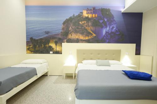Ένα ή περισσότερα κρεβάτια σε δωμάτιο στο Nazzarì B&B Tropea