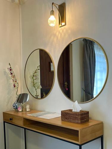 two mirrors on a counter in a room at Dolphin Circle Bed and Breakfast in Plettenberg Bay