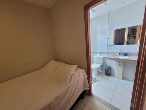 a small bedroom with a bed and a sink at Samambaia East Side · Comfort in Samambaia in Brasilia