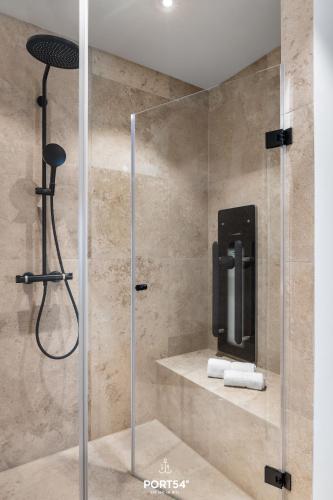 a shower with a glass door in a bathroom at Waterfront Suite List auf Sylt in List