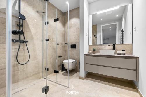 a bathroom with a shower and a toilet and a sink at Haven Suite List auf Sylt in List