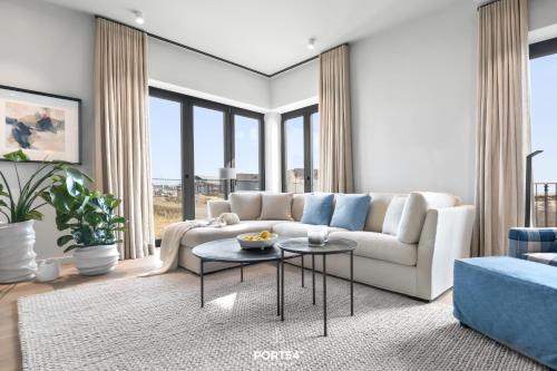 a living room with a white couch and a table at Sunrise Suite List auf Sylt in List