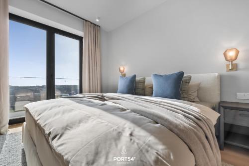 a bedroom with a bed with a dog on the blanket at Harbourview Suite List auf Sylt in List