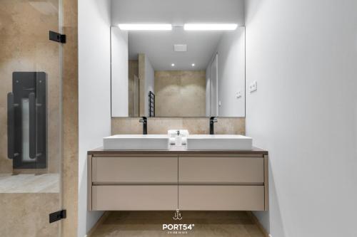 a bathroom with a sink and a mirror at Harbourview Suite List auf Sylt in List