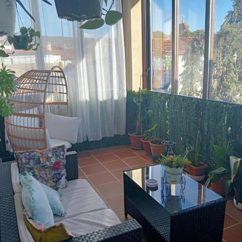 a balcony with a chair and a table and plants at Habitación ideada para parejas con Jacuzzi, desayuno romántico y opción de cenas en su restaurante in Villamiel