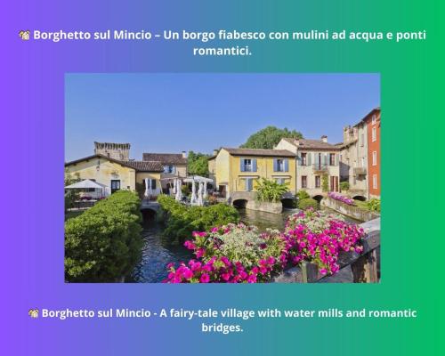 a view of a town with a river and flowers at Barbudo's House in Lonato del Garda