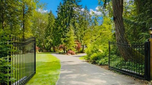 a driveway with a black gate in a park at Joy House in Woodinville