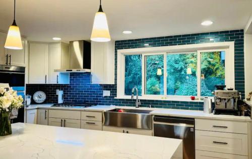 a kitchen with a sink and a large window at Joy House in Woodinville