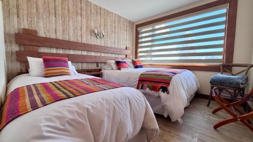 Entre Cumbres Apart Hotelにあるベッド