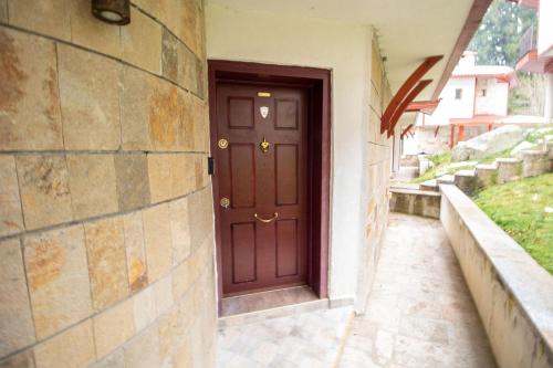 a brown door on the side of a building at 2 bedroom, 2 showeroom Villa suitable for a family skication and remote working in Pamporovo