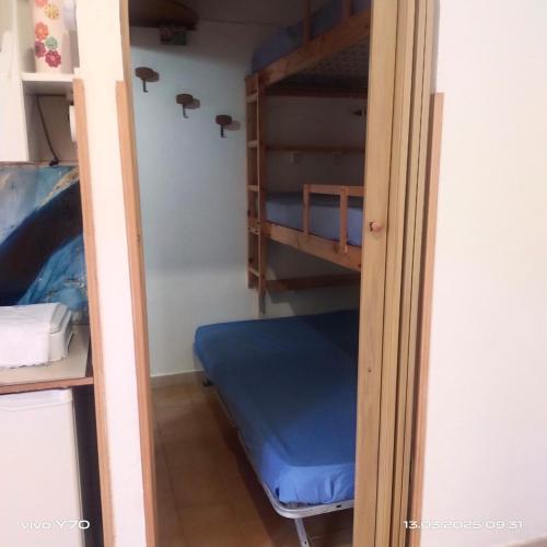 a room with bunk beds and a blue bed at Casa Vacanza Il Pontile Mini Appartamento in Cipollina