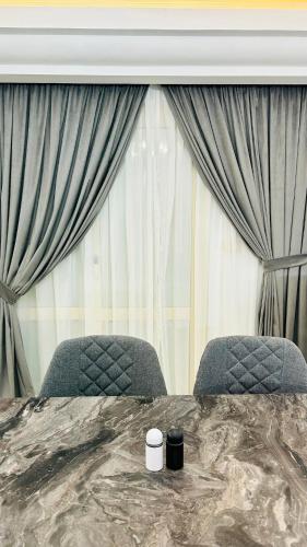a bedroom with two chairs in front of a window at Your Home Flat in Cairo in Cairo