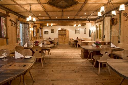 a dining room with wooden tables and chairs at Rasmushof - Hotel Kitzbühel in Kitzbühel