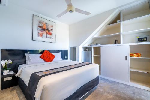 a bedroom with a large bed and a ceiling fan at Bali Yarra Villas - Seminyak in Seminyak