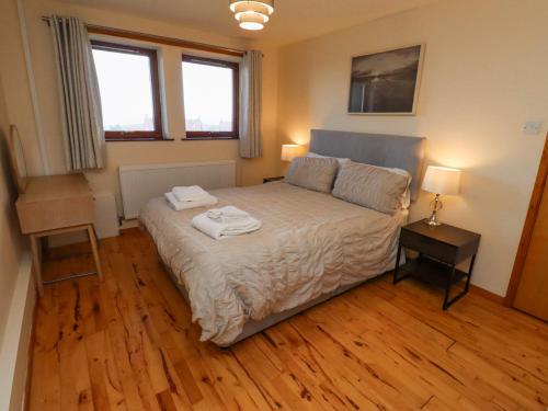 a bedroom with a bed with two towels on it at Waters Edge in Alnwick