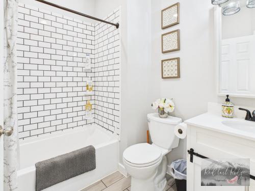 a white bathroom with a shower and a toilet at Historical Albany Downtown House with 5 Bedrooms in Albany