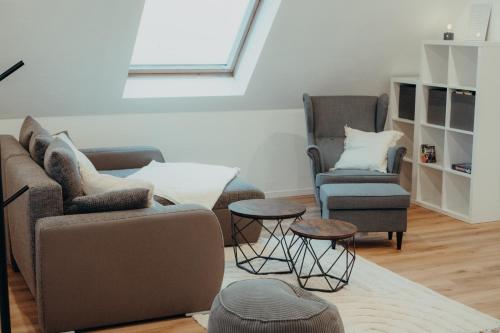 a living room with two couches and two chairs at EifelNest Blankenheim 2 in Blankenheim