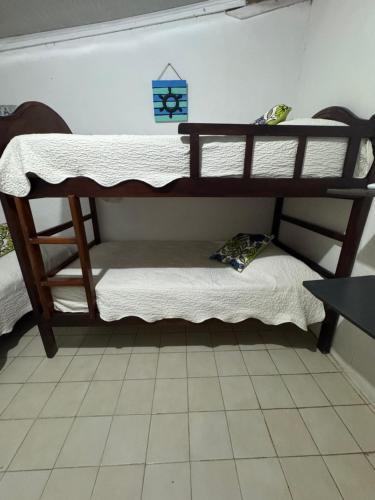 two bunk beds in a room with a table at Helena's Place in San Andrés