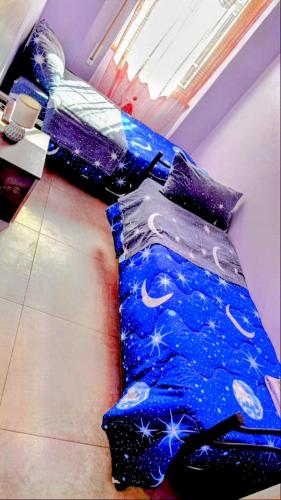 two beds in a room with a blue comforter at Villa Paoletti, appartamento confortevole nel cuore di Gradara in Gradara
