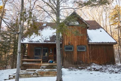 a wooden house with snow on the roof at Rippling Waters close to Timberline ski slopes in Cortland