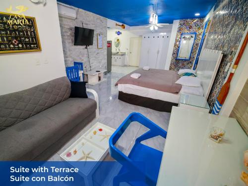 a hotel room with a bed and a couch at Casa María in Isla Mujeres
