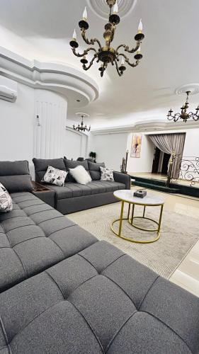 a living room with a couch and a table at Your Home Flat in Cairo in Cairo