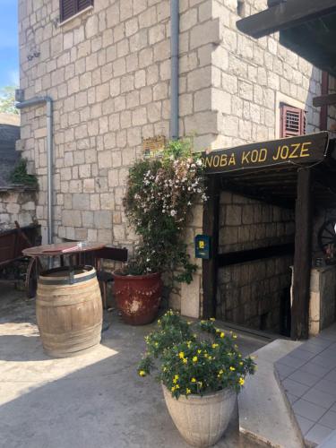 a patio with a table and flowers in front of a building at Old Town House Manosa Split in Split