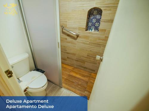 a small bathroom with a toilet and a window at Casa María in Isla Mujeres