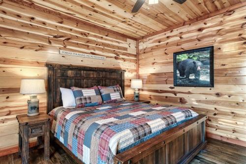 a bedroom with a bed in a log cabin at Smoky Mountain Splash in Sevierville
