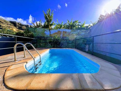 a swimming pool in a yard with a fence at Apartamento El Platanal in Tazacorte