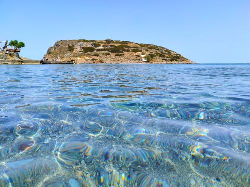 an island in the middle of a body of water at Lemon & Waves Mochlos in Mochlos